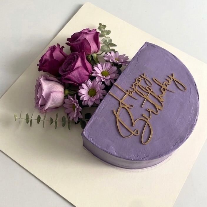 Half-moon lavender birthday cake with purple roses
